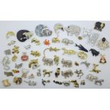 A collection of fifty-four brooches including two lucite cat brooches and others including