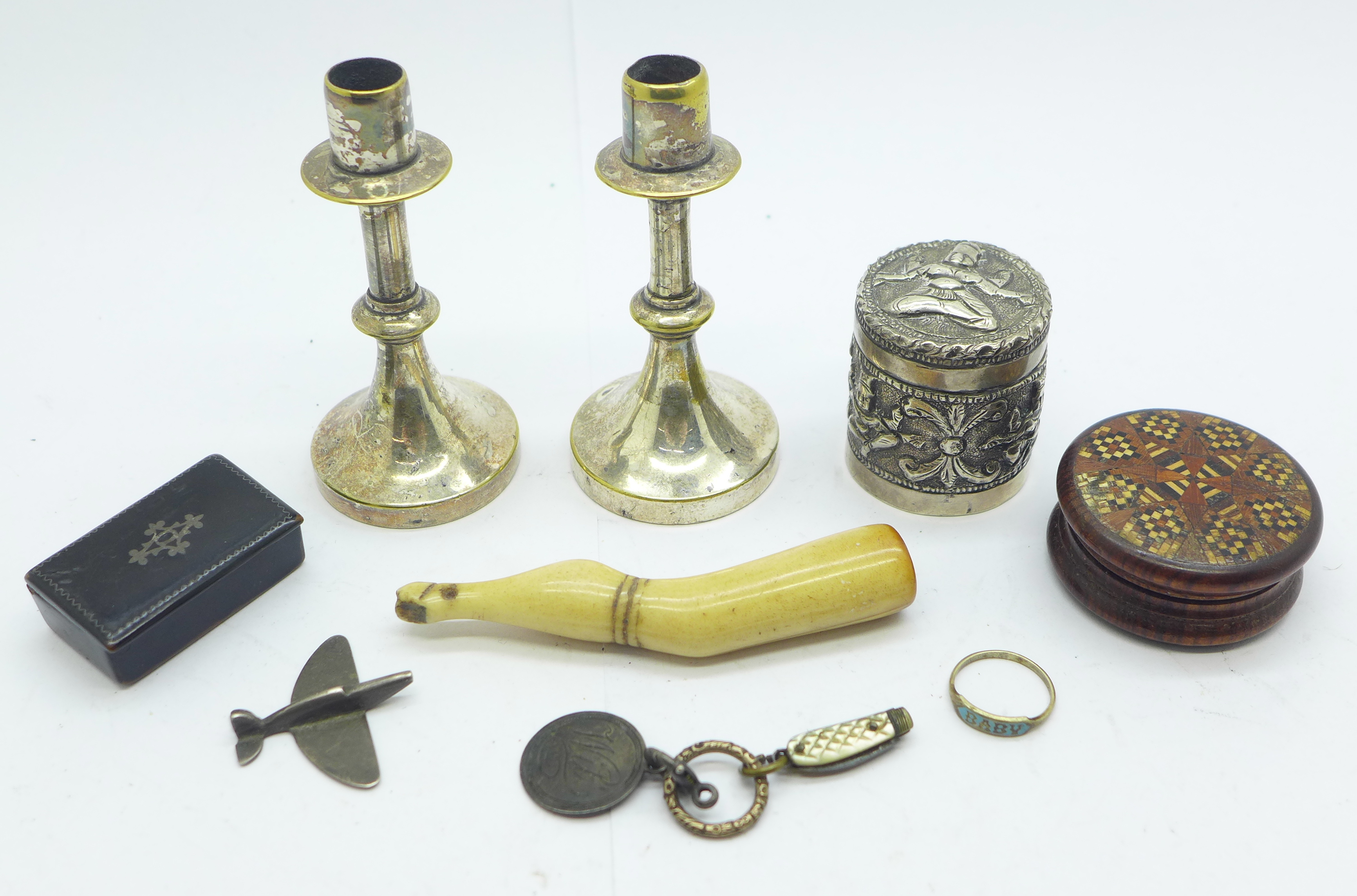 A pair of small candlesticks, a snuff box, a pipe tamp, a circular pot with lid, a very small