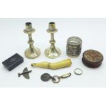 A pair of small candlesticks, a snuff box, a pipe tamp, a circular pot with lid, a very small