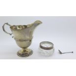 A silver helmet shaped cream jug, hallmarks rubbed, 83g, 9.5cm, and a silver rimmed glass salt and