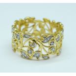 A pierced silver gilt ring with diamond accent, T