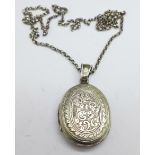 A Victorian locket on a silver chain, (locket tests as silver), locket 25mm x 31mm