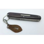 A multitool knife, personalised to T.E. Pryce Tannatt, (fly fishing author), worn names on the