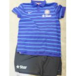 An Indian cricket polo shirt and a pair of shorts