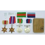 Four WWII medals with ribbons, the box addressed to F.R. Day, Pinner