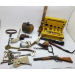A collection of pipes, cased weights, corkscrews, keys, toy rifle, etc.