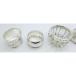 Two pairs of silver napkin rings, 61g, and a silver rimmed glass salt