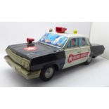 A tin-plate Japanese Highway Patrol car, one roof spotlight missing, 34cm