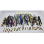 Ten ink pens, eighteen ballpoint pens, six propelling pencils and pen parts, nibs, etc.