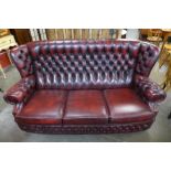 A red leather Chesterfield settee