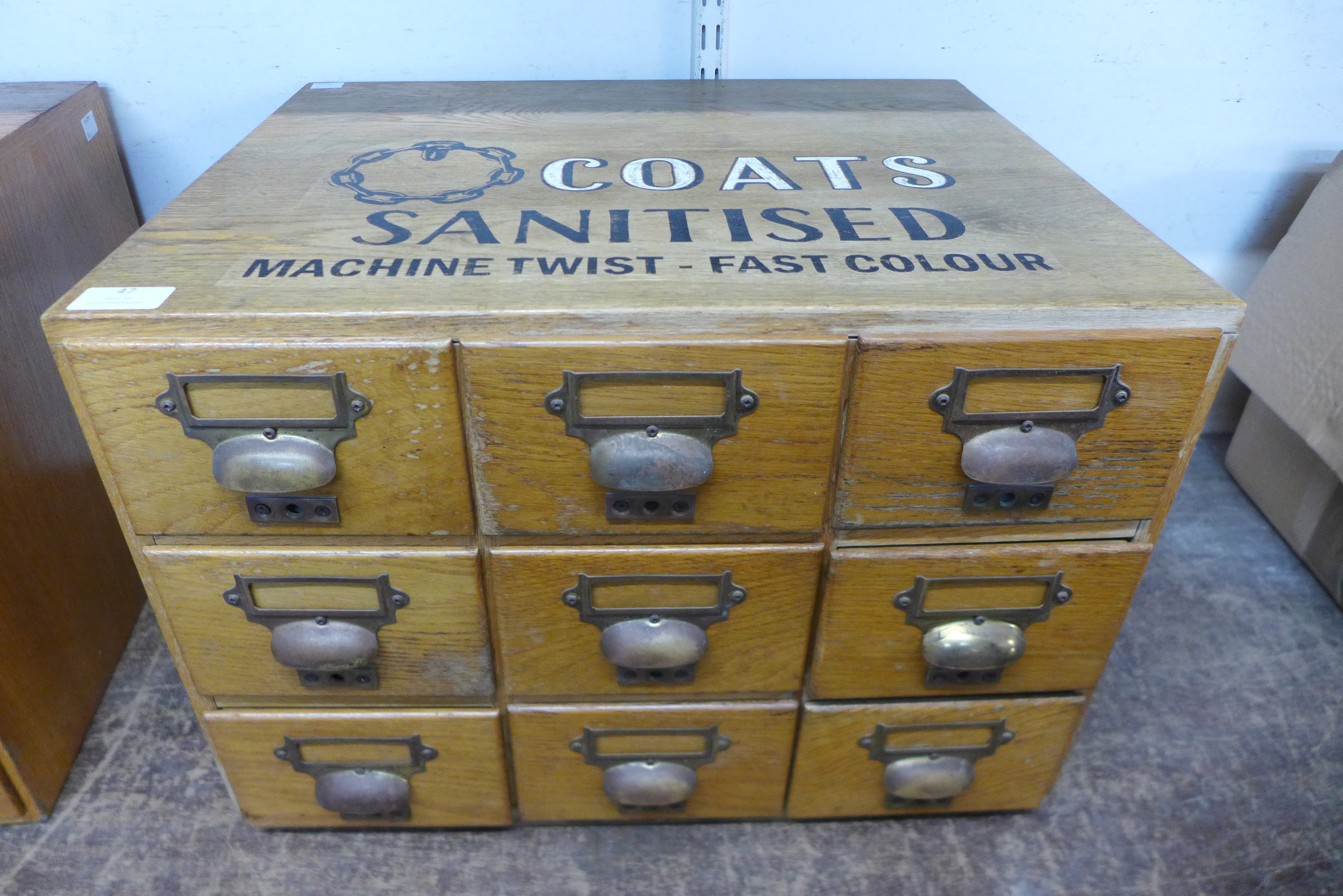 An oak table top nine drawer index filing cabinet, bearing Coats Sanitised inscription