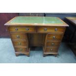 A George III style yew wood and green leather topped kneehole desk