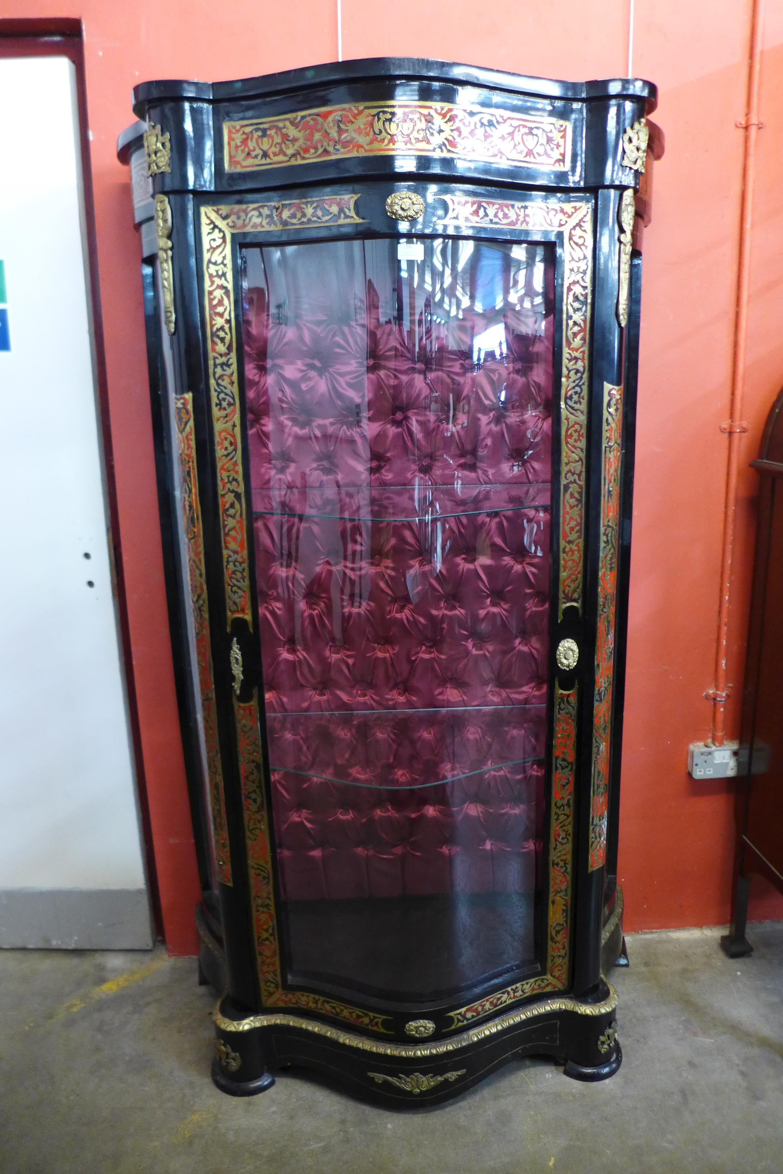 A French Boulle style ebonised, brass and faux tortoiseshell serpentine vitrine