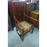 An Arts and Crafts mahogany armchair