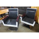 A pair of Art Deco style barber's chairs