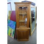 A pine freestanding corner cabinet