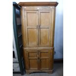 A George III pine splay front freestanding corner cupboard