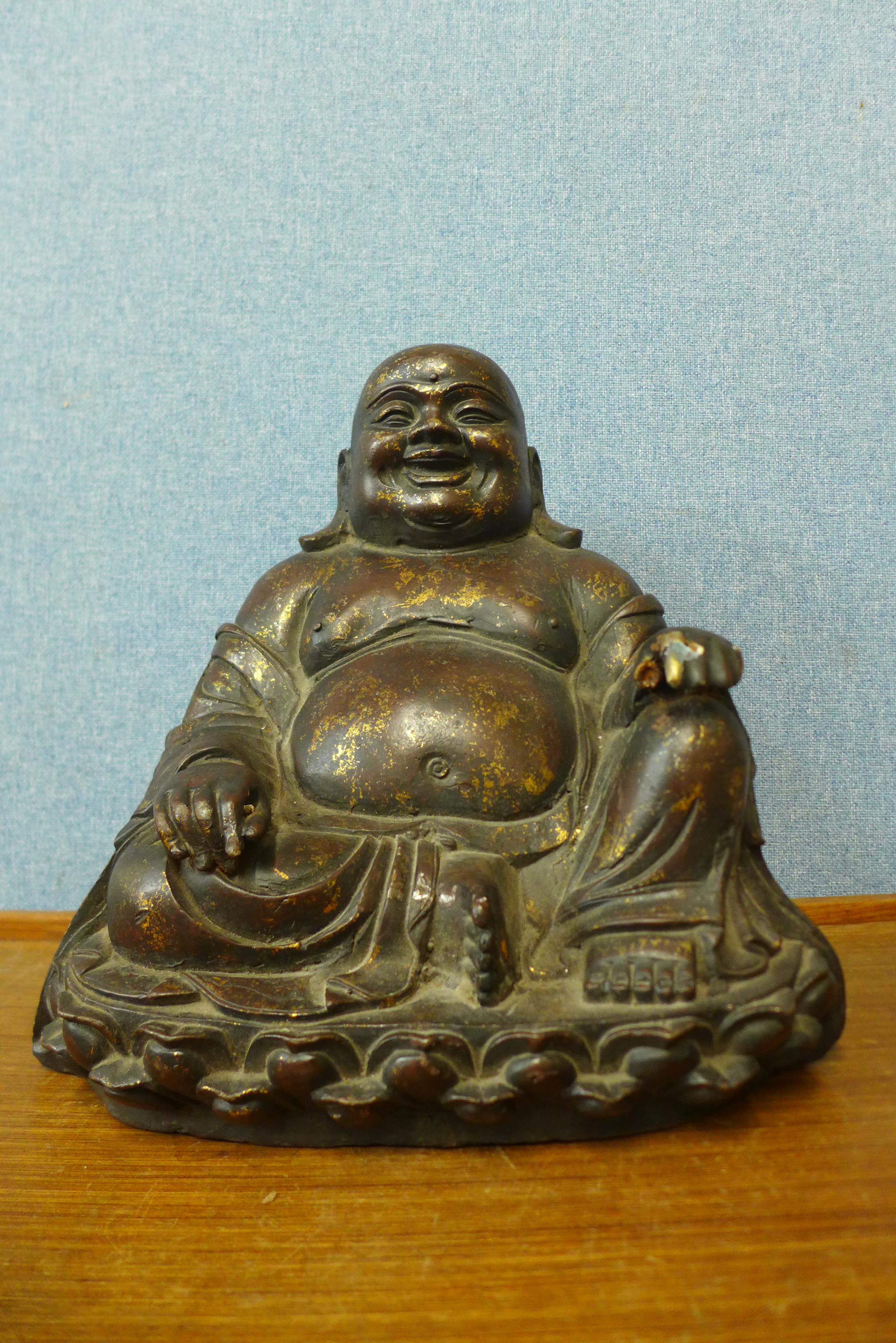 An oriental bronzed figure of seated Buddha, 33cms h