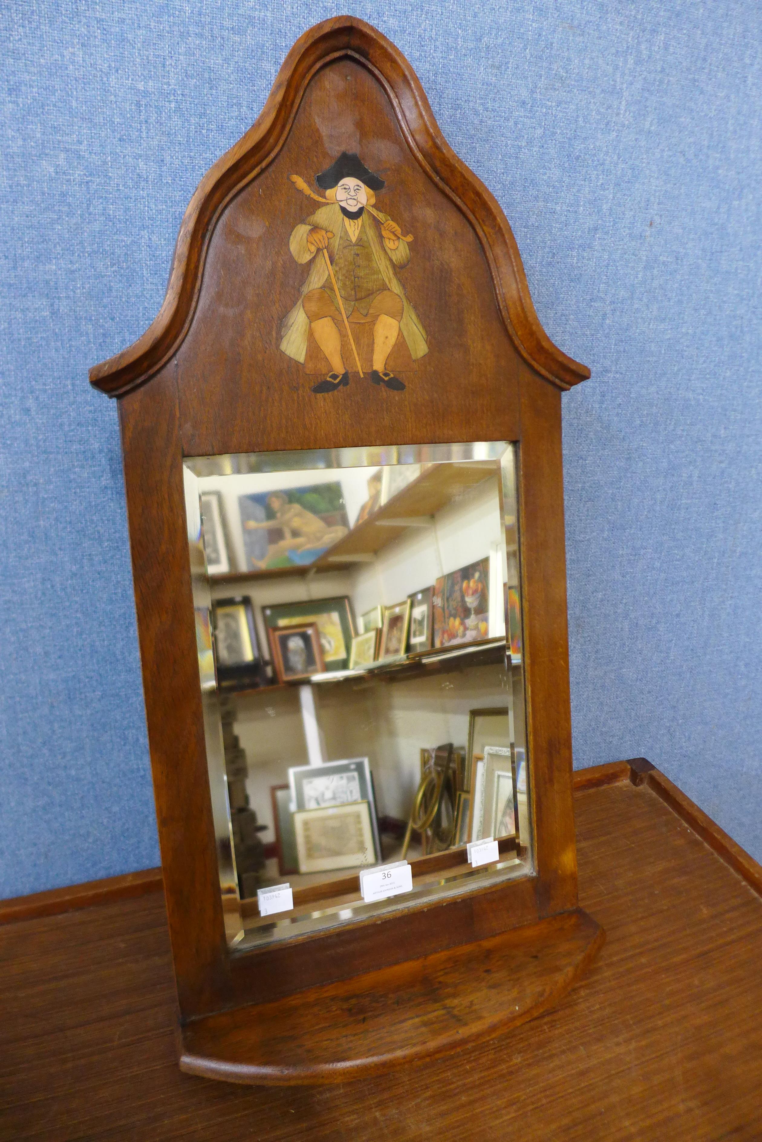 An Arts and Crafts inlaid oak hall mirror, attributed to Liberty & Co., 69cms h