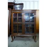An Edward VII carved oak two door bookcase