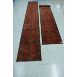 A pair of red ground runner rugs