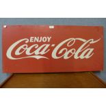 A painted metal Coca-Cola advertising sign