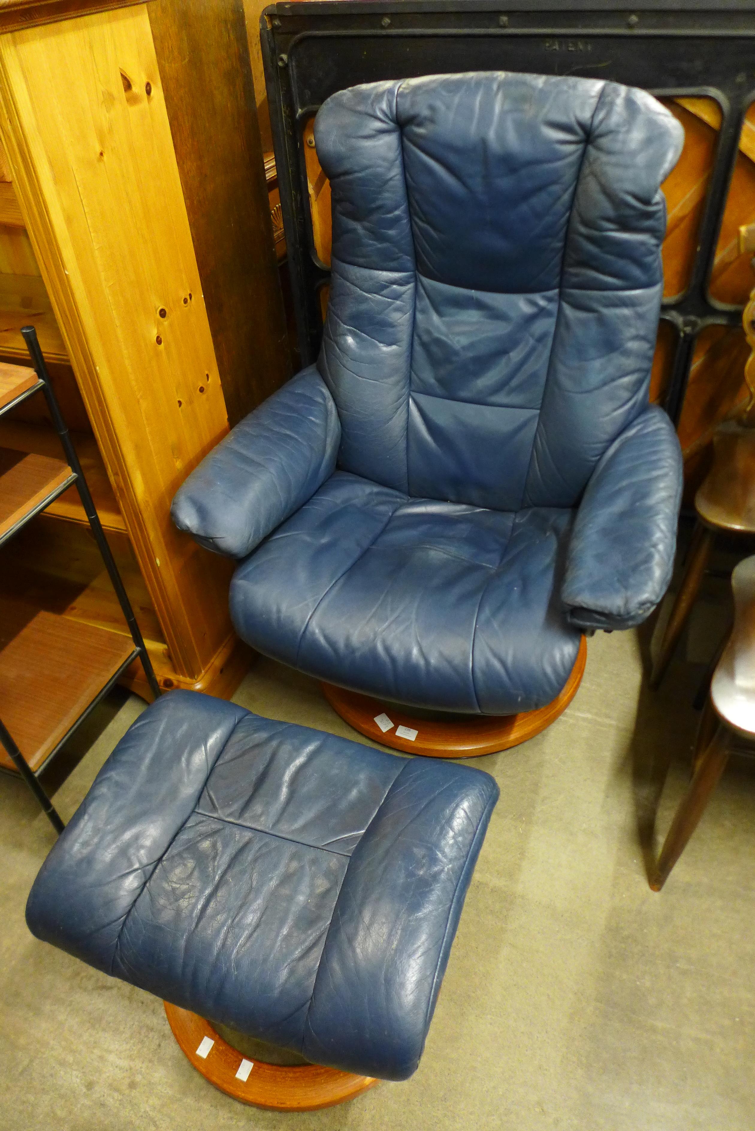 A beech and leather swivel armchair and stool