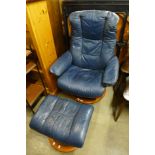 A beech and leather swivel armchair and stool