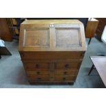 A 17th Century style oak geometric moulded bureau