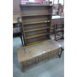 An oak open bookcase and a carved oak blanket box