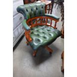 A beech and green leather revolving desk chair