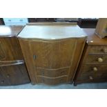 An Art Deco oak serpentine tallboy