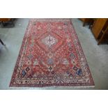 An eastern red ground geometric patterned rug, 253 x 163cms