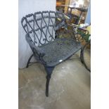 A cast iron garden table, two chairs and bench