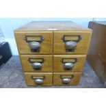 An oak table top six drawer index filing cabinet