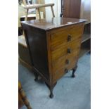 An oak four drawer music cabinet