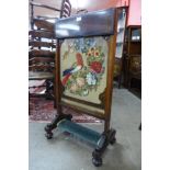 An early Victorian rosewood and embroidered fire screen