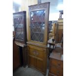 A carved oak freestanding corner cabinet