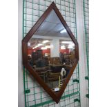 An oak framed diamond shaped mirror