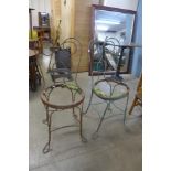 A pair of wrought iron garden chairs