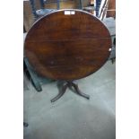 A George III oak circular tilt-top tea table and three chairs