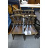 A set of four Ercol Golden Dawn elm and beech fleur de lys chairs