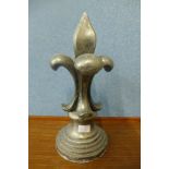 An aluminium fleur de lys finial