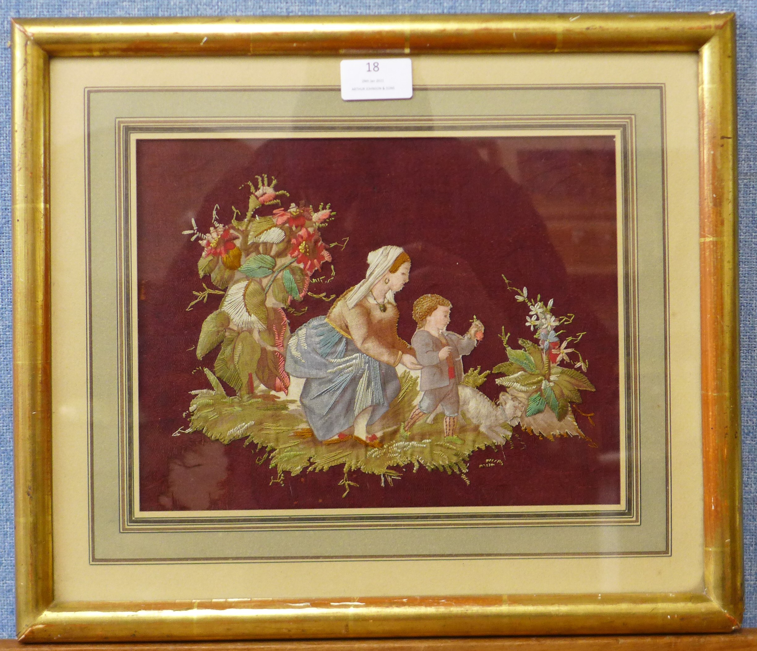 A Victorian silkwork embroidery of mother and child, 20 x 26cms, framed