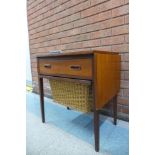 A teak and rattan drop-leaf sewing table