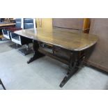 An Ercol dark elm refectory table