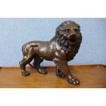 A bronze figure of a lion, 23cms h