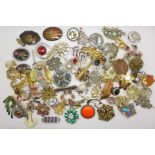 A collection of over eighty costume brooches