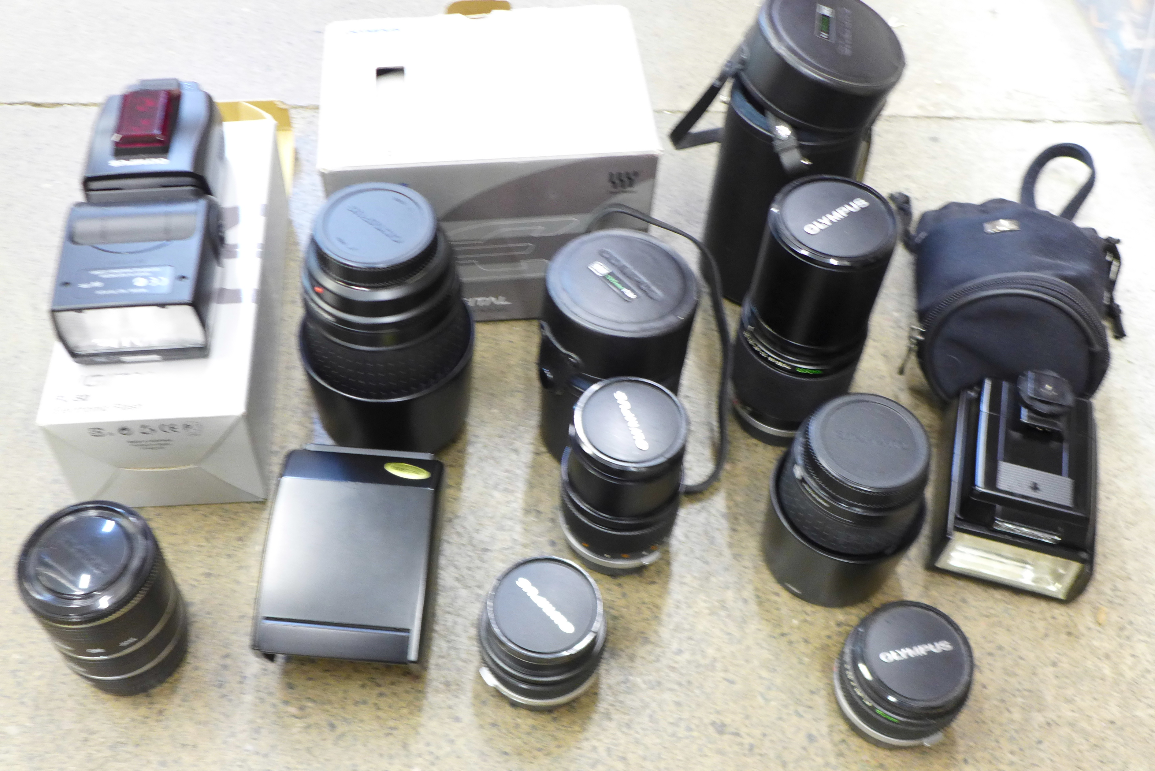 Six Olympus camera lenses including Zuiko digital ED 70-300mm, 200mm F4, 35mm, 28mm, 135mm,