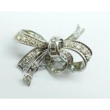 A white metal and diamond bow brooch, 7.5g, width 33mm